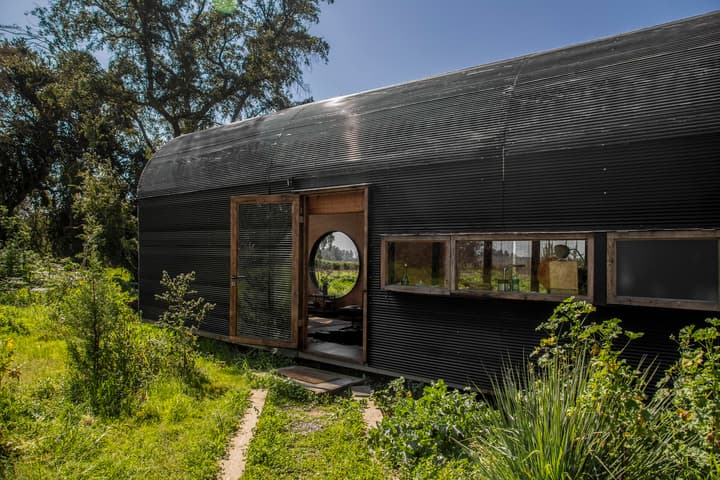 A vaulted structure designed to seamlessly integrate with Chile's verdant landscape