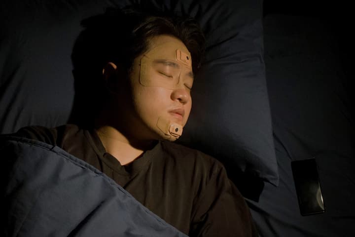 The two thin patches transmit sleep data to the user's smartphone via Bluetooth